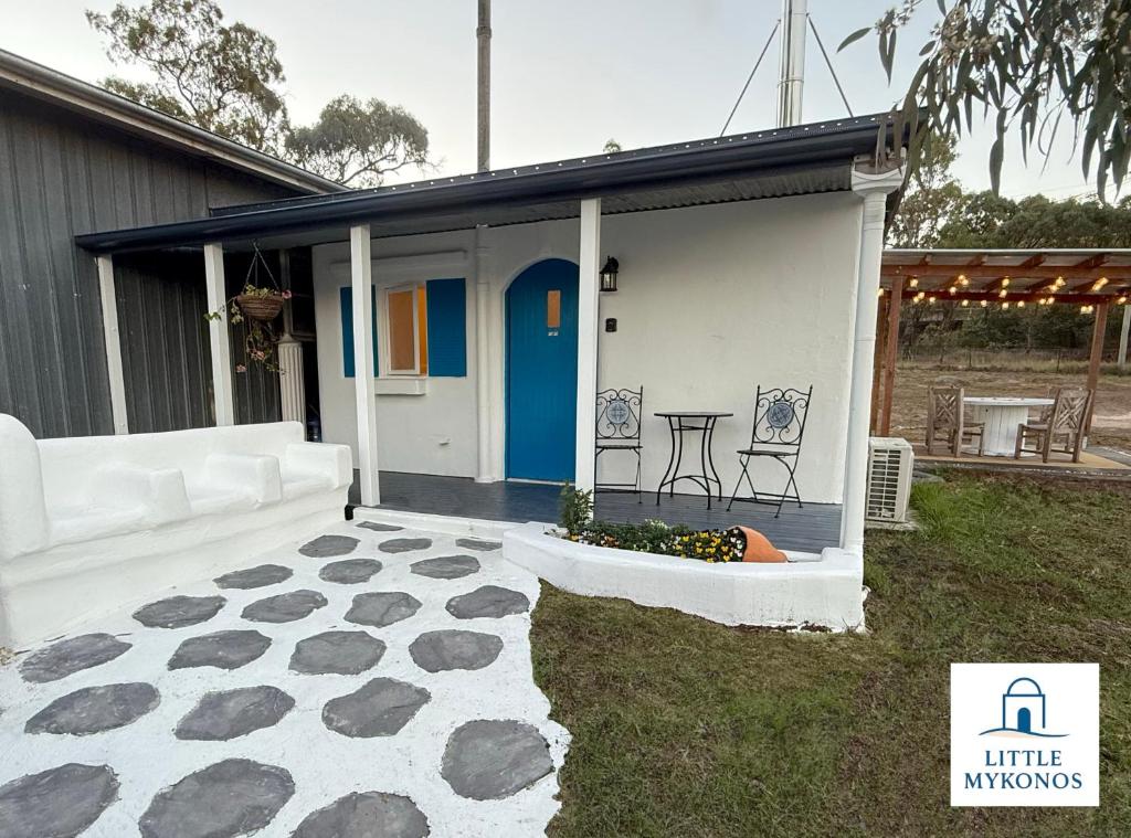 a house with a patio and a table in the yard at Little Mykonos right here in Stanthorpe! in Stanthorpe