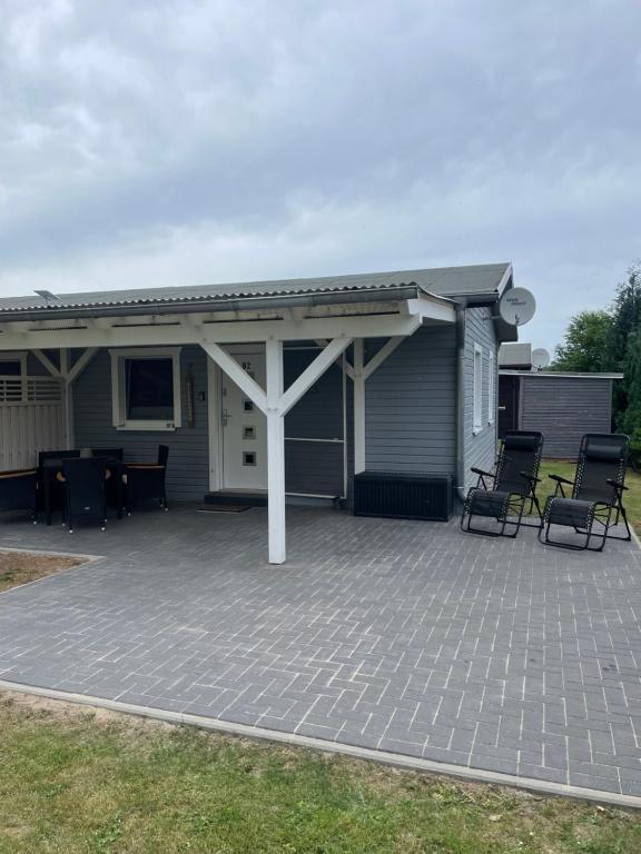 a house with a patio with chairs on it at Ferienhaus Usedom in Kamminke