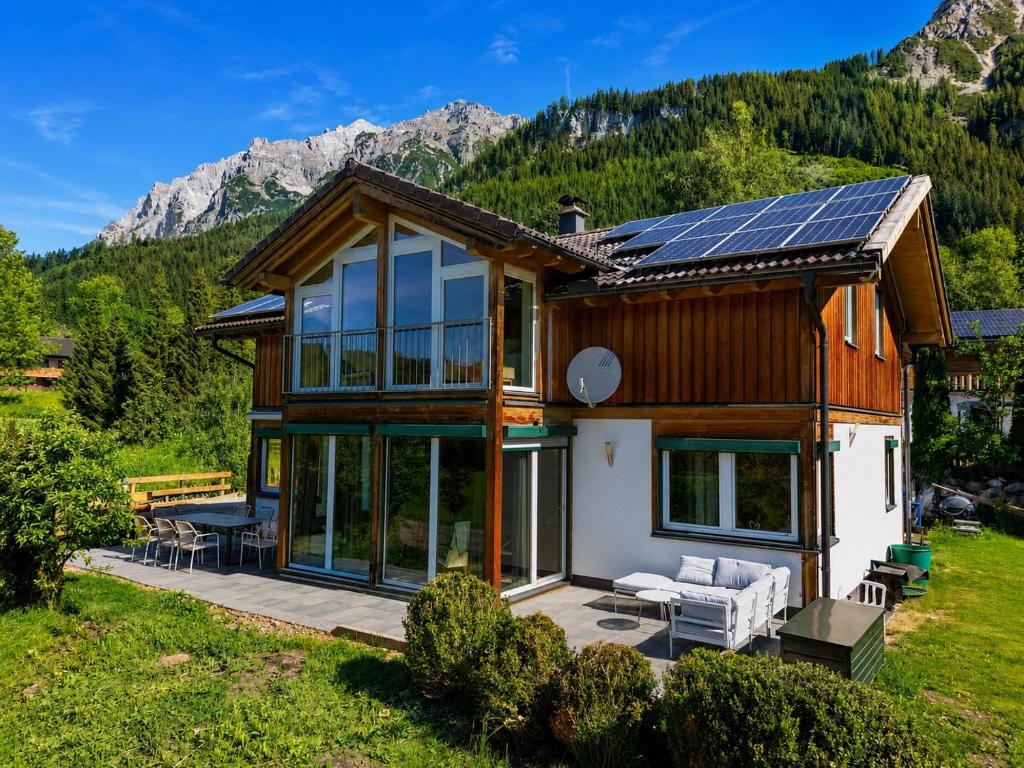 a house with solar panels on the roof at Gipfelruhe-ganzes Ferienhaus mit Sauna, Garten & Spielzimmer- Ramsau am Dachstein in Ramsau am Dachstein