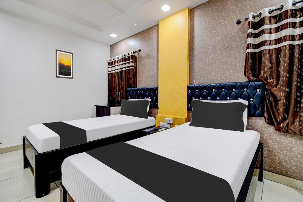 a hotel room with two beds at Hotel O Rajadhani in Guntūr