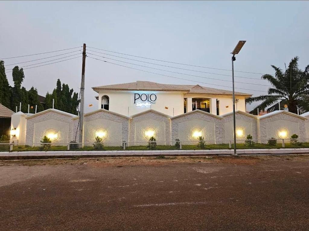 a large white building with the word poo on it at Polo Signature Hotel in Kaduna