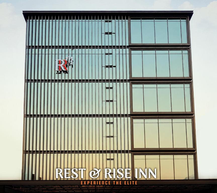 a tall building with a sign on the side of it at Rest and Rise Inn in Bhīmavaram