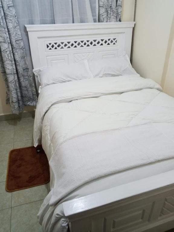 a white bed with white sheets and pillows at Halcon Homes Machakos Boma Yangu in Machakos