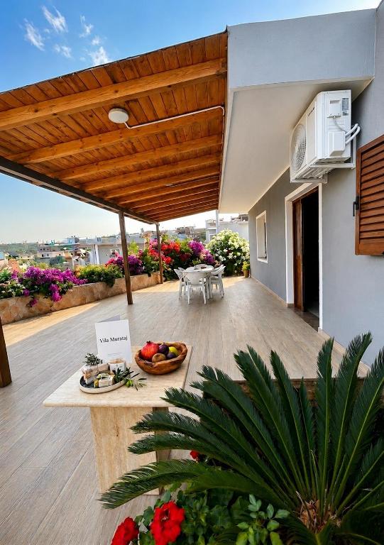 a patio with a table with fruits and vegetables on it at Villa Murataj in Ksamil