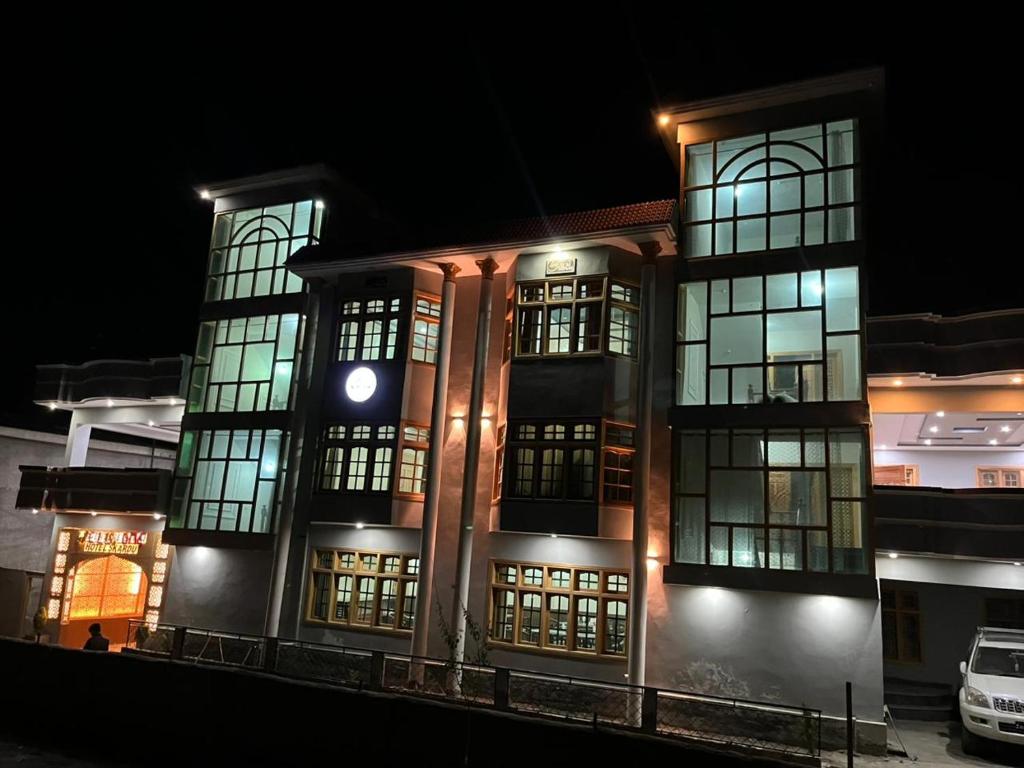 a lit up building with windows at night at cloudrestskardu in Skardu