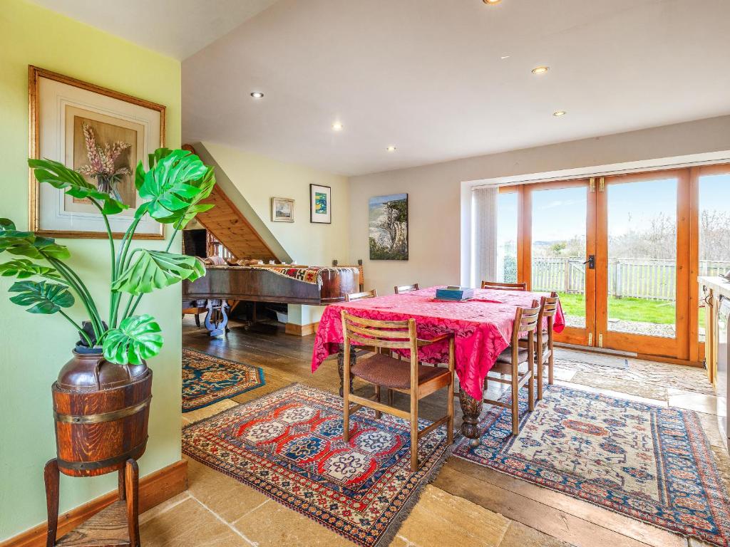 a dining room with a table and a piano at Seaton Court - Uk31955 in Staithes