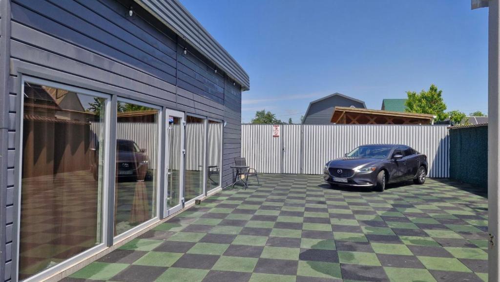 a car parked in a parking lot next to a building at Villa Dacha in Izmail