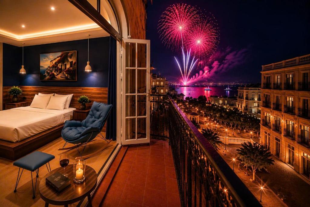 a hotel room with a bed and a balcony with a fireworks display at Tiamo Hotel in Phú Quốc