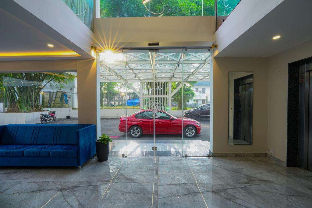 a red car is parked in a garage at Tiger Hill Hotel & Suites in Kalpetta