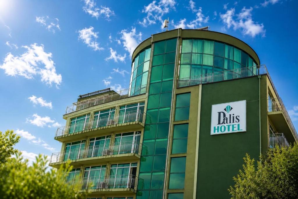 a tall green building with a sign on it at Dalis Sunny Beach in Sunny Beach