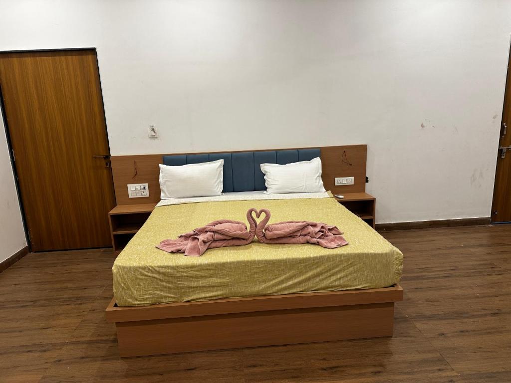 a bedroom with a bed with a bow on it at Hotel RK Palace in Sehot