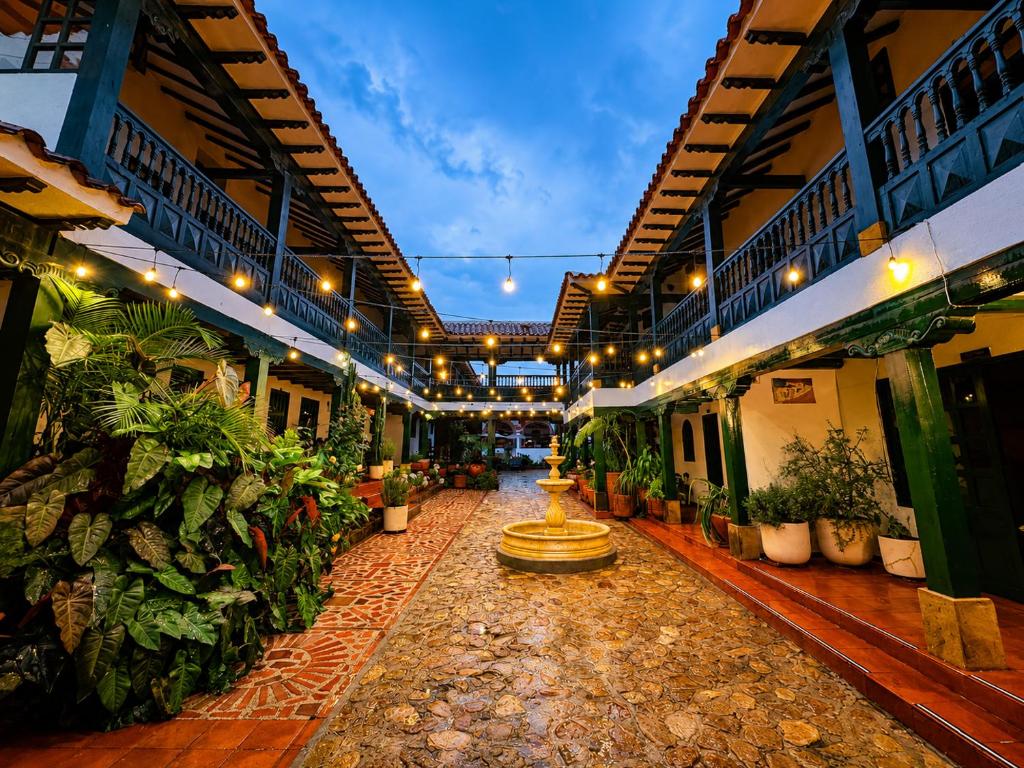 a hallway with a fountain in the middle of a building at Hotel Beth Sarim in Villa de Leyva