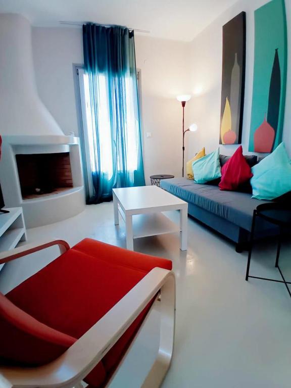 a living room with a couch and a table at Aktaea, Seaside Residence in Santa Maria