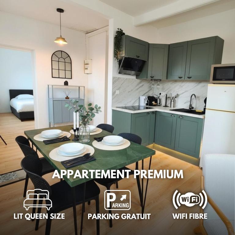 a kitchen with green cabinets and a table with plates on it at L'Éclat du Miroir - AbsoluteHome in Croix