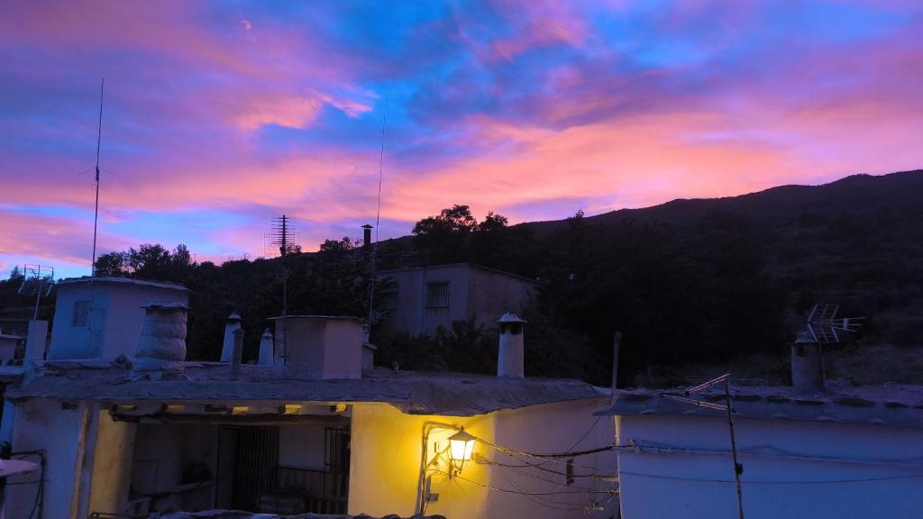 a view of a sunset from a house at Casa MANES in Pitres