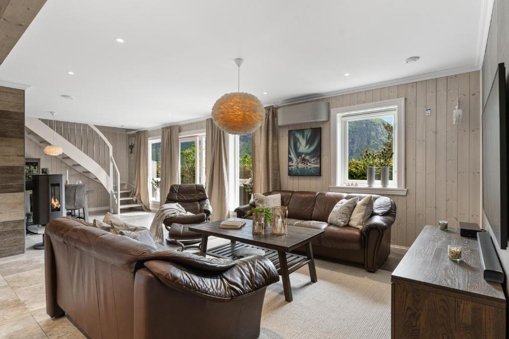 a living room with a couch and a table at Hus i Stryn med utsikt in Stryn