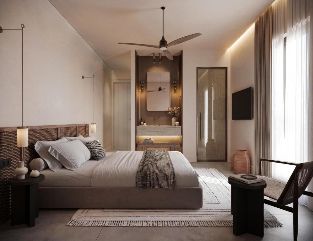 a bedroom with a large bed and a mirror at Breaq Santorini - Margarita Hotel in Firostefani