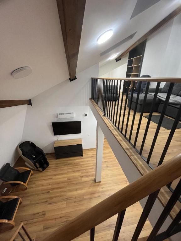 a room with a staircase and a living room at Central View Penthouse & Parking in Târgu-Mureş