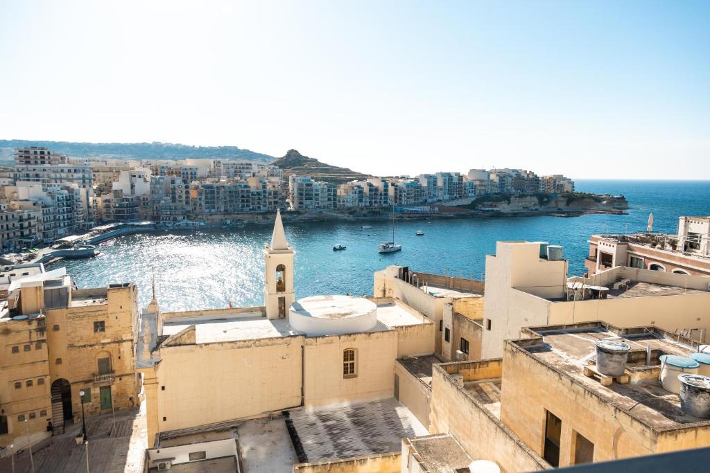 an aerial view of a city with a church at Marsalforn Panorama Penthouse in Marsalforn