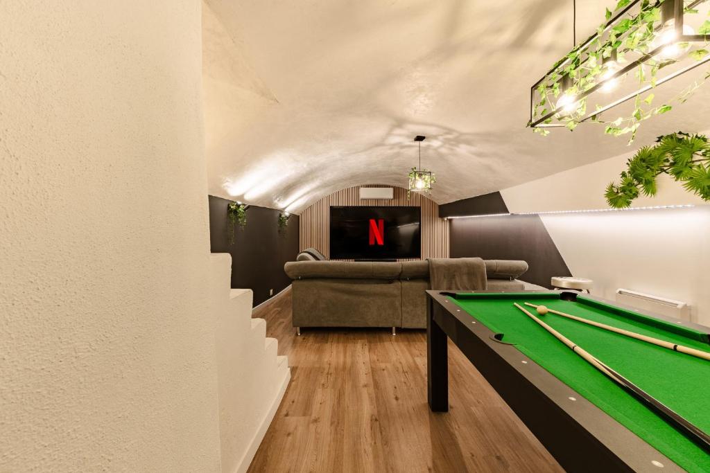 a living room with a pool table and a couch at La Cave Voutée - Home Cinema in Valence