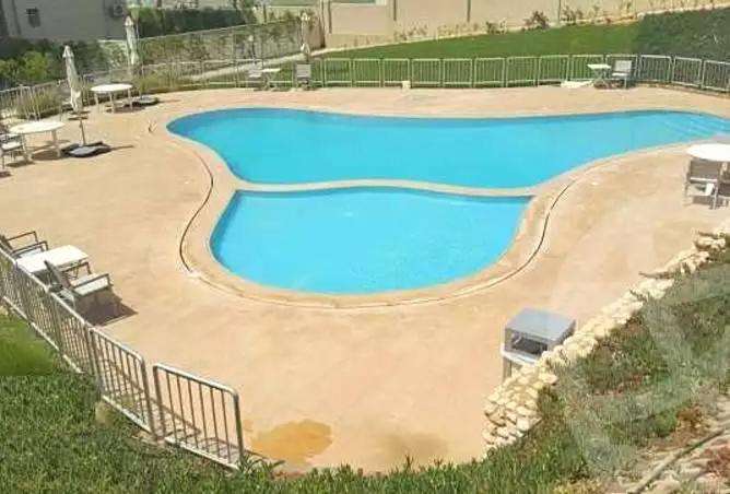 a large pool with blue water in a yard at Modern 3-BR gated Sheikh Zayed Compound Open Views in Sheikh Zayed