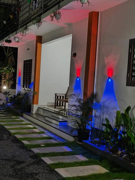 a house with blue lights on the side of it at Havens Nature Homestay in Ambalavayal
