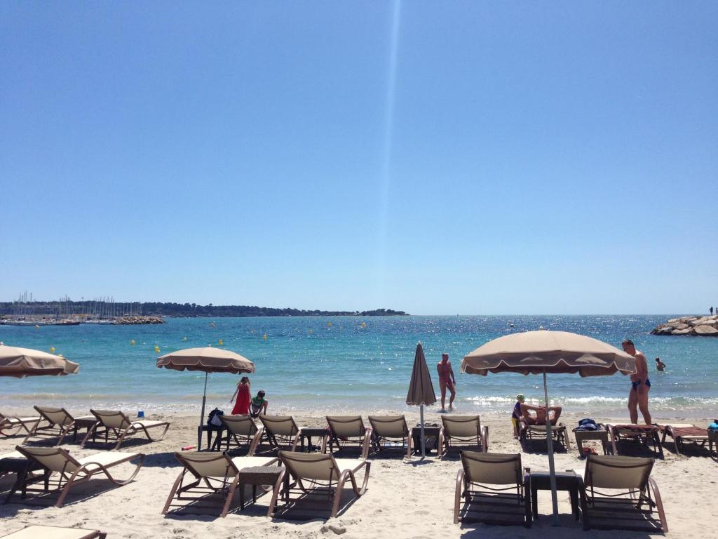 a group of chairs and umbrellas on a beach at STUDIO by the croisette in Cannes