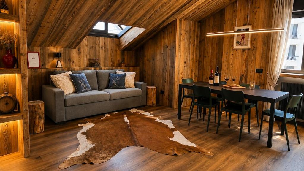 a living room with a couch and a table at Appartamento Arisch in Aprica