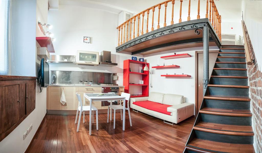 a living room with a staircase and a kitchen at Miniloft-Angy-Navigli in Milan