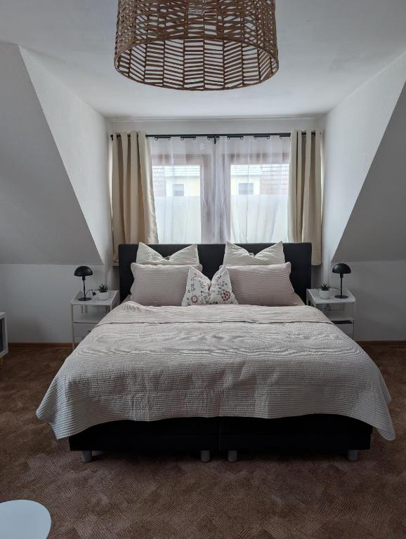 a bedroom with a large bed with a large window at Apartment am Park Anklam in Anklam