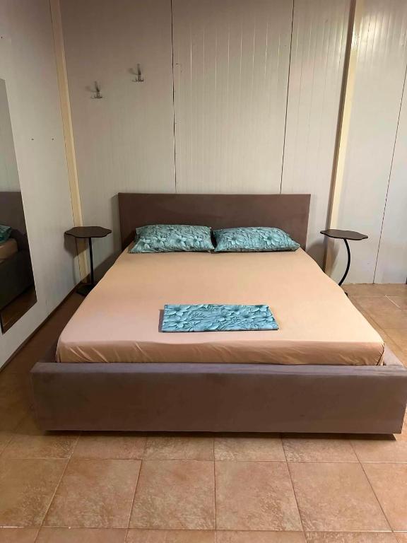 a large bed in a room with two tables at IGI Apartments in Bogorodica