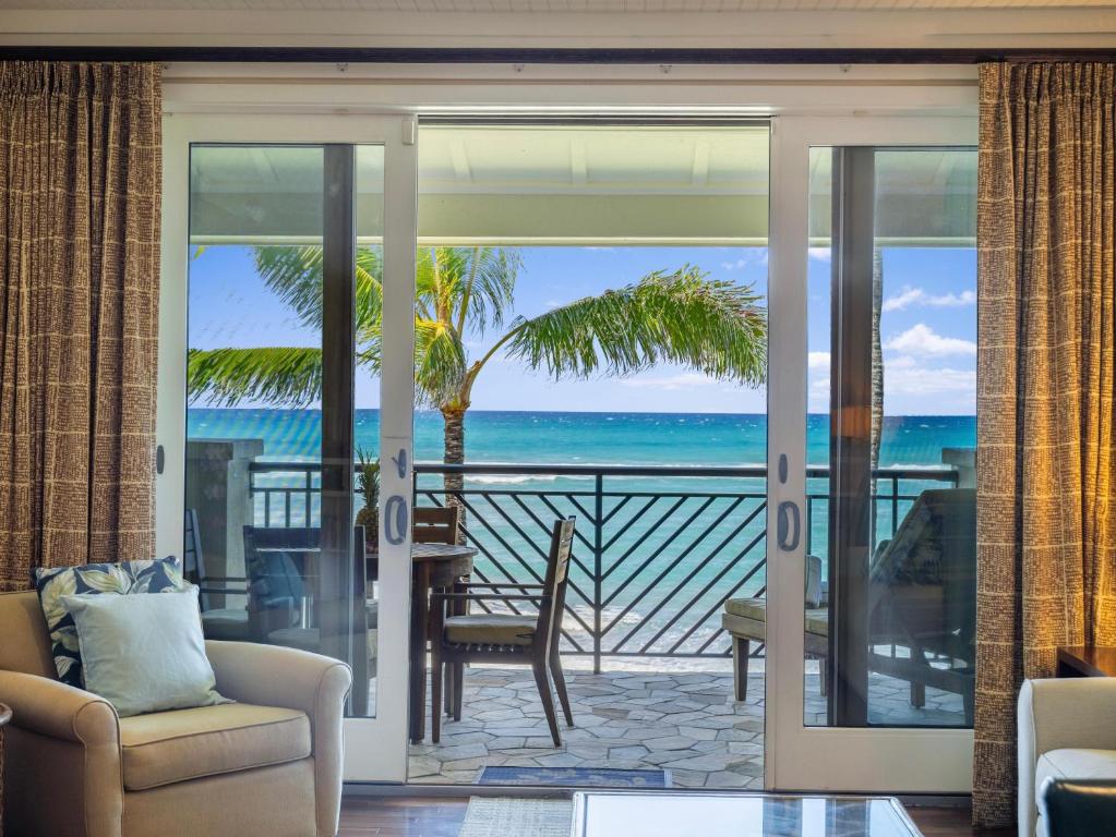 a living room with a view of the ocean at Villa 317 at Turtle Bay in Kahuku