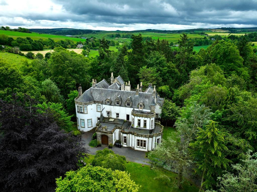 an aerial view of a large house in the forest at Edinburgh Country Estate Rooms & Apartments in Gorebridge