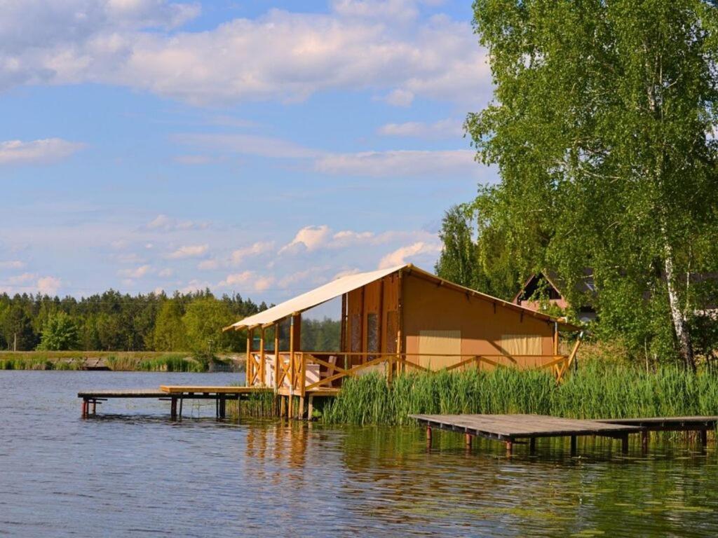 a cabin in the middle of a body of water at Царів Хутір in Tsarivka
