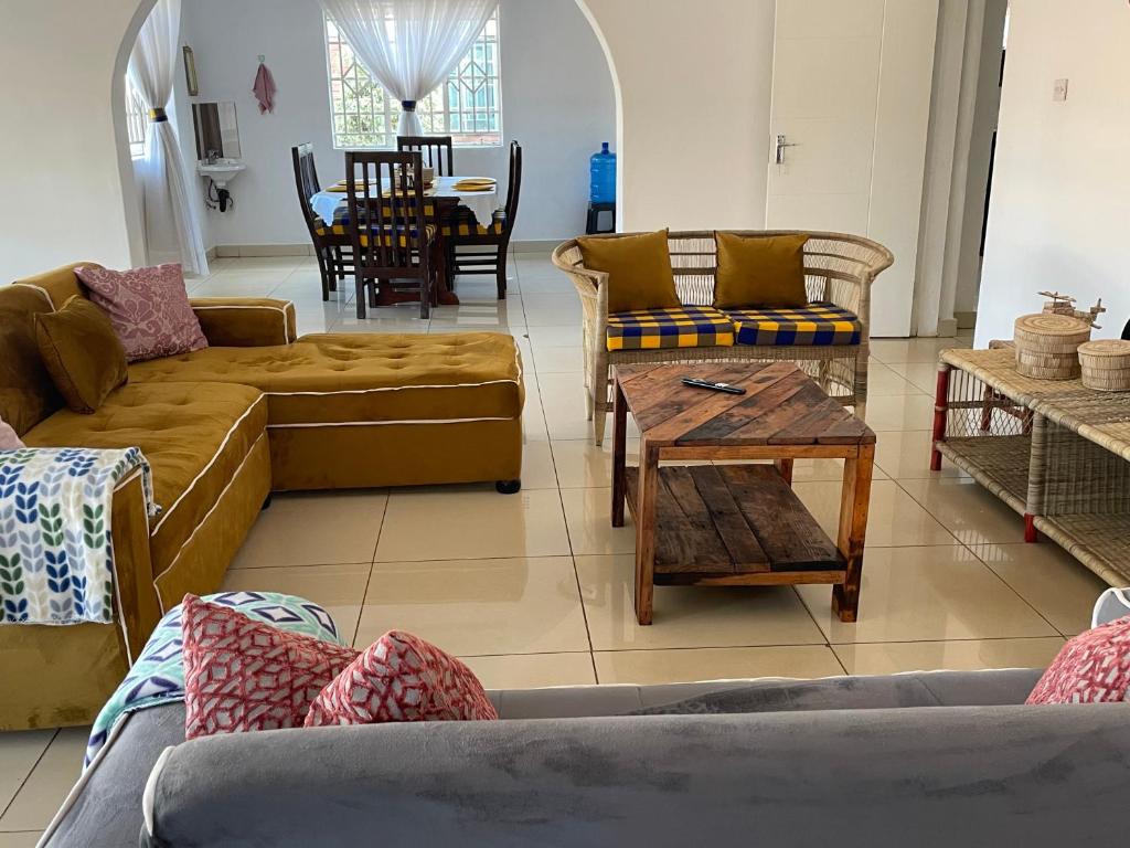 a living room with couches and a table at Suzie's Nest 2 in Lilongwe
