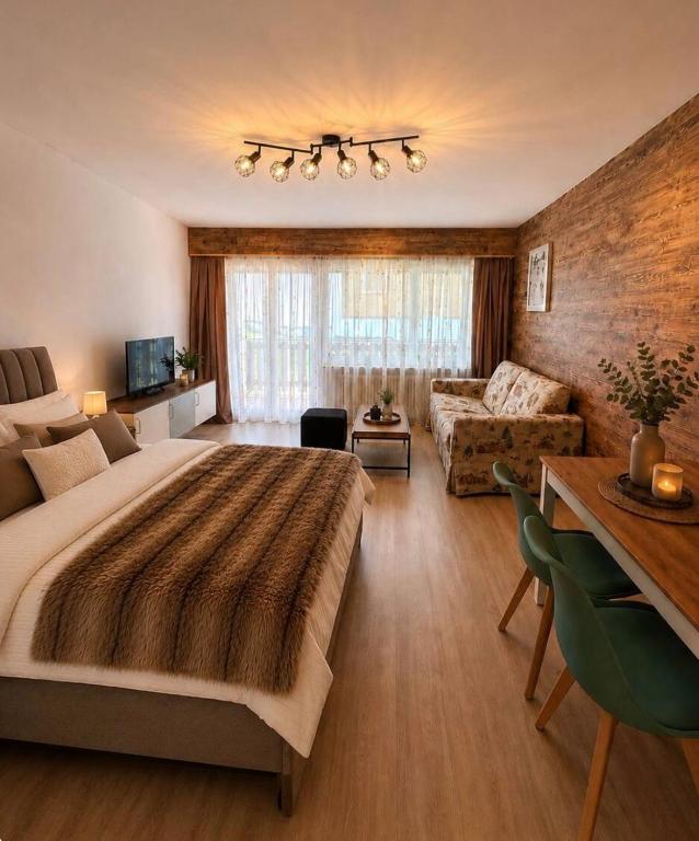 a bedroom with a large bed and a living room at Holiday Leukerbad Ruhe Natur Berge Free Parking 80 in Leukerbad