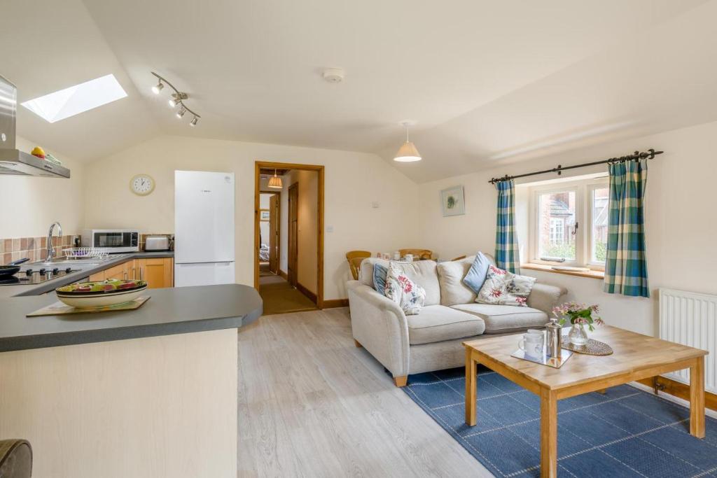 a kitchen and living room with a couch and a table at 2 Bed in Denton oc-b42753 in Kenton