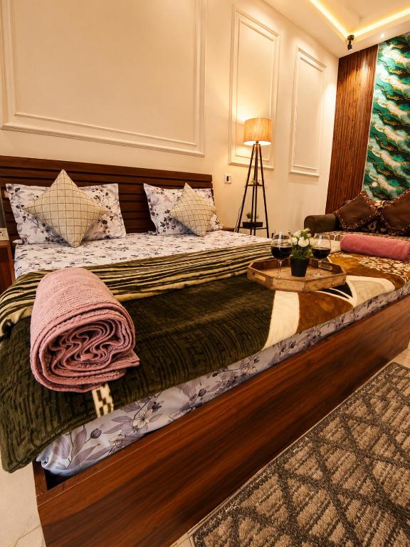 a bedroom with a large bed with a table on it at Darshana Studios# Couple Friendly in Noida