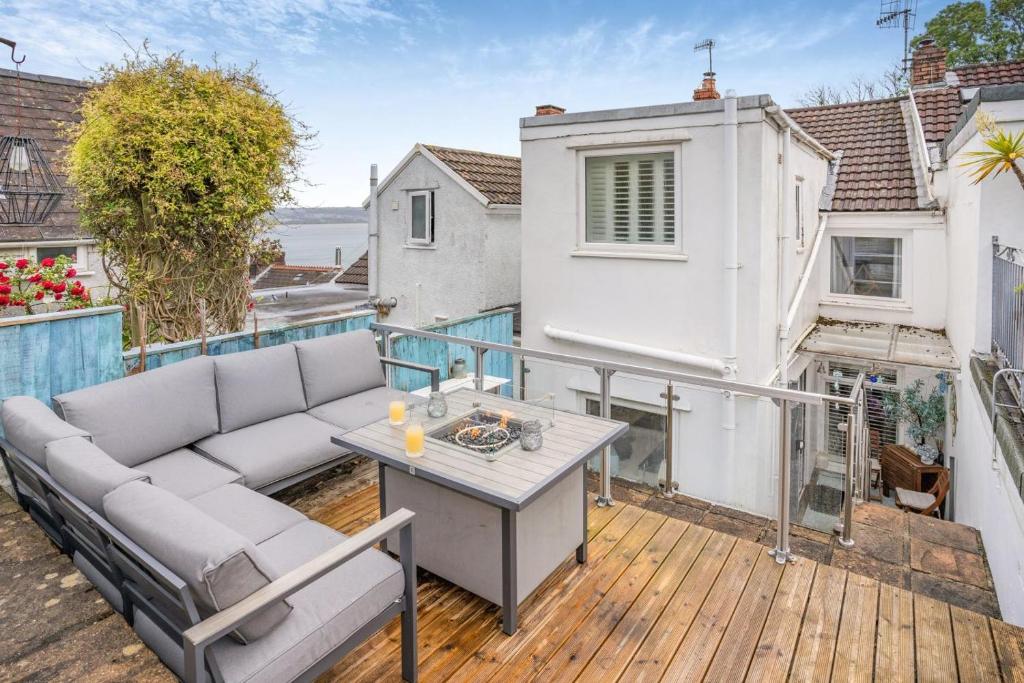 a balcony with a couch and a table on a deck at 2 Bed in Mumbles oc-t42823 in The Mumbles