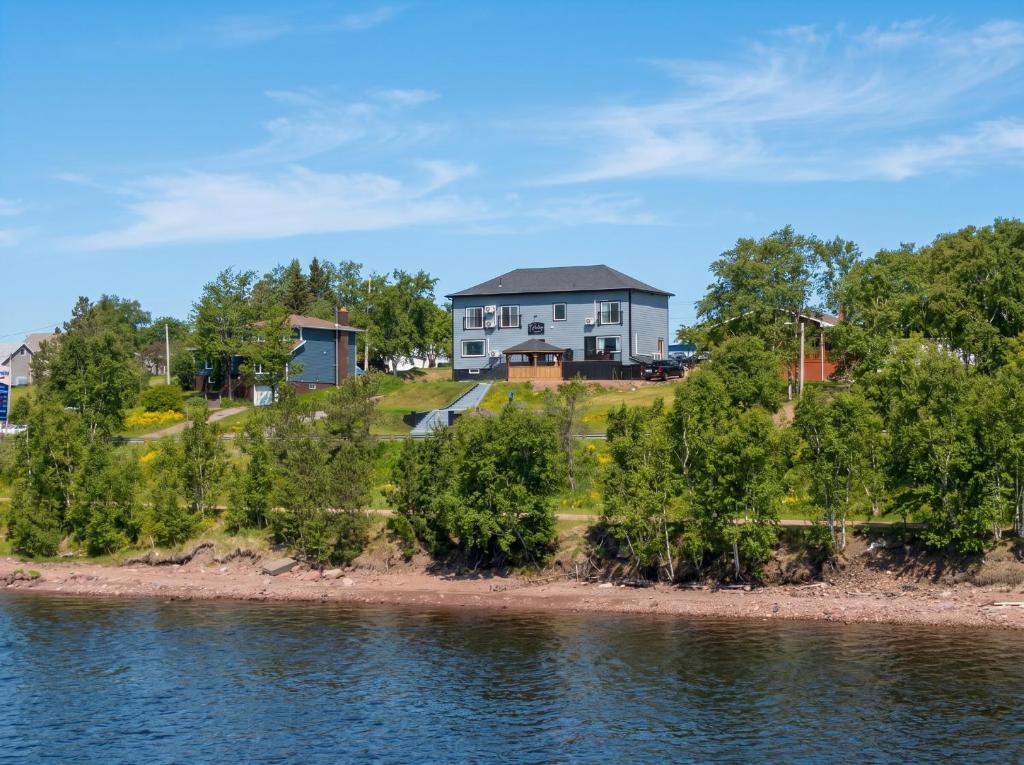 a house on the shore of a body of water at Falkenberg Business Centre and Suites in Botwood