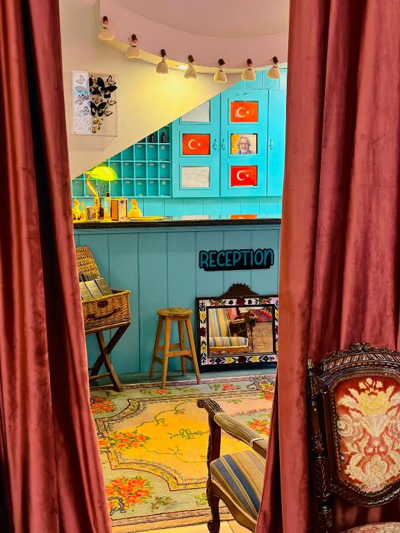 a red curtain in a room with a bar at Sufi Homes in Konya