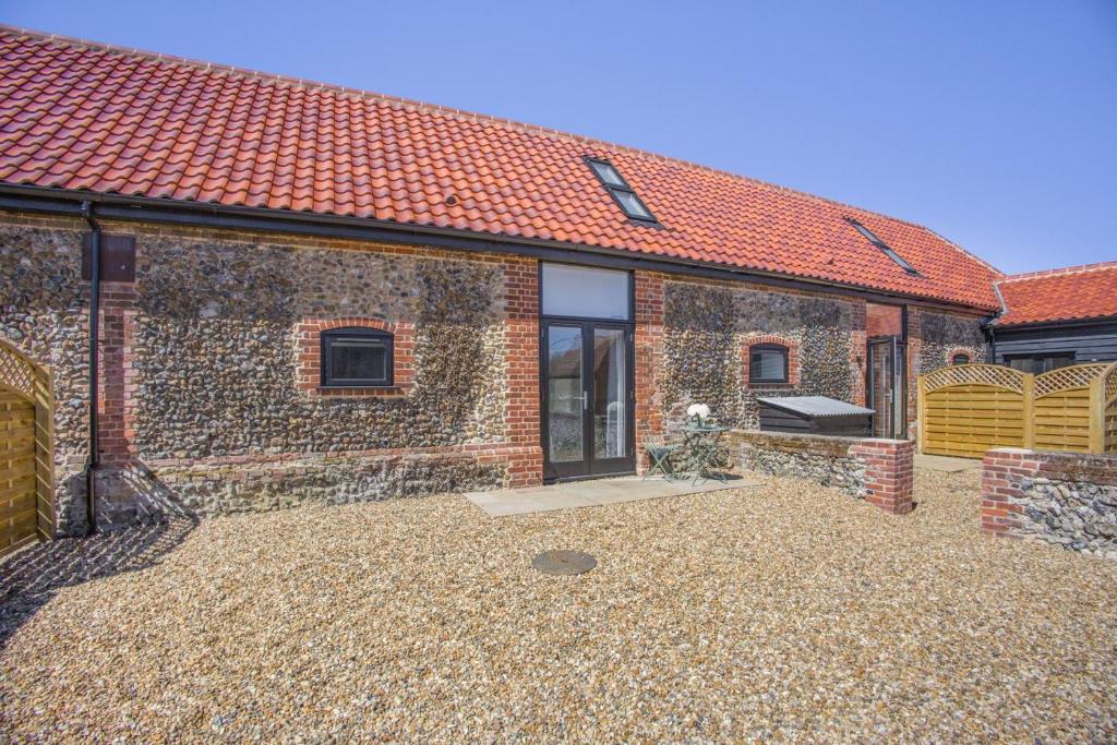 a brick house with a large patio in front of it at 1 Bed in Barrow oc-b42641 in Barrow
