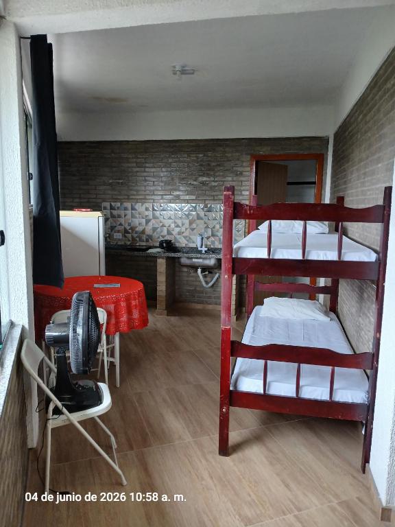 a room with two bunk beds and a kitchen at Studio na Serra I in Itatiaia