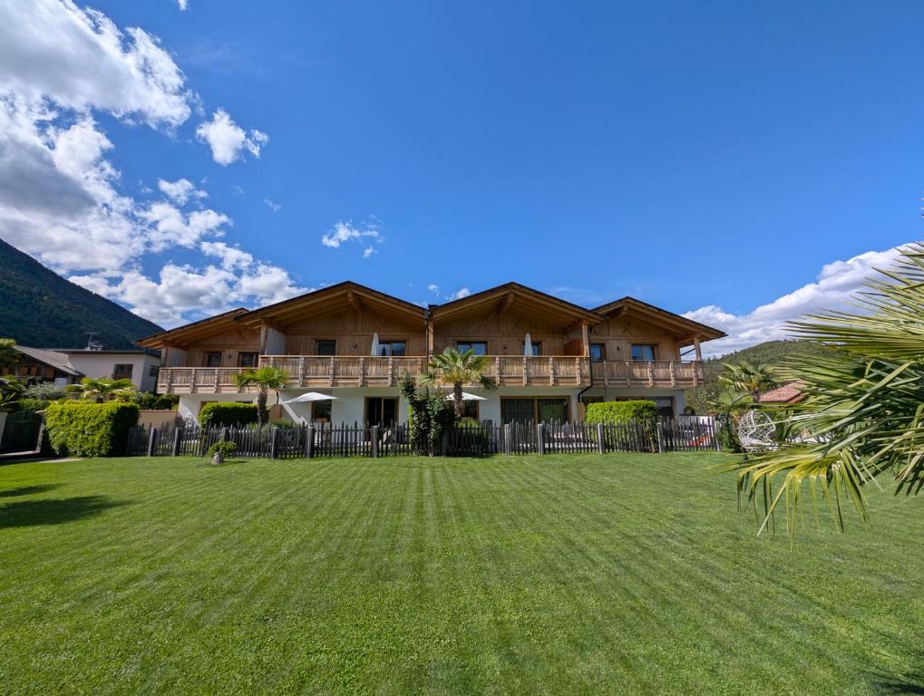 a house with a lawn in front of it at Chalet Schaller in Missiano