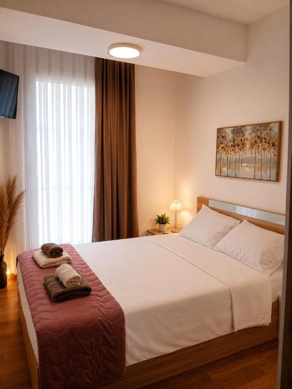 a bedroom with a large bed with a red blanket at SOLU Luxury Apartments with Free Parking ,Fast Wi -Fi, New Building in Skopje