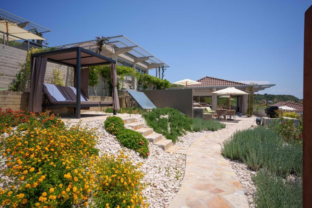 a garden with a bench and a gazebo at Turtle Home in Skala