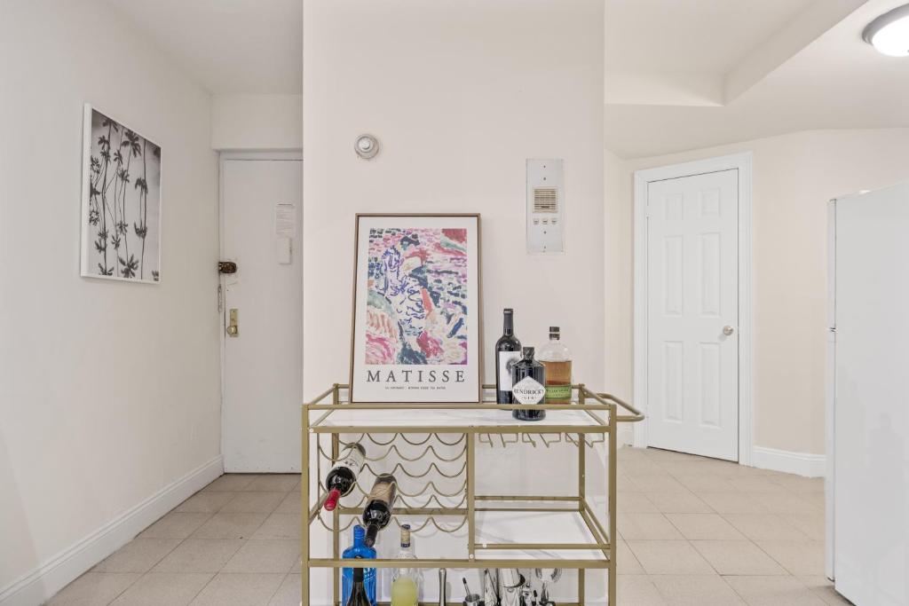 a room with a table with wine bottles on it at Chic One Bedroom Retreat in Downtown Manhattan in New York