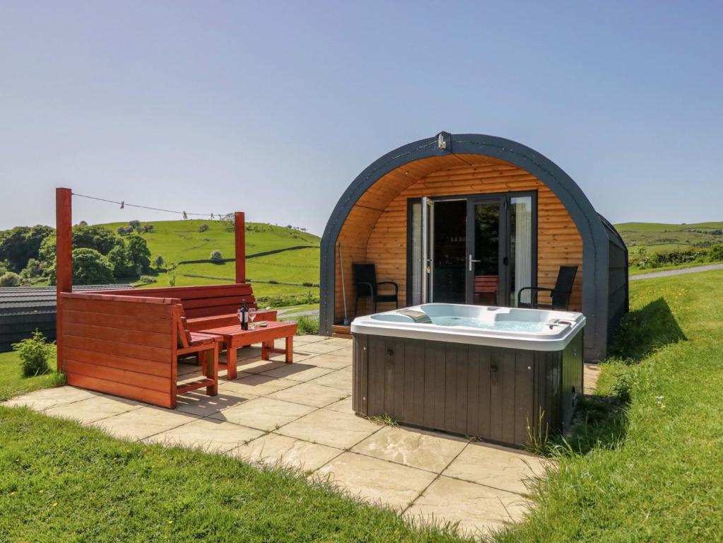 a gazebo with a hot tub and a bench at Willow in Ulverston