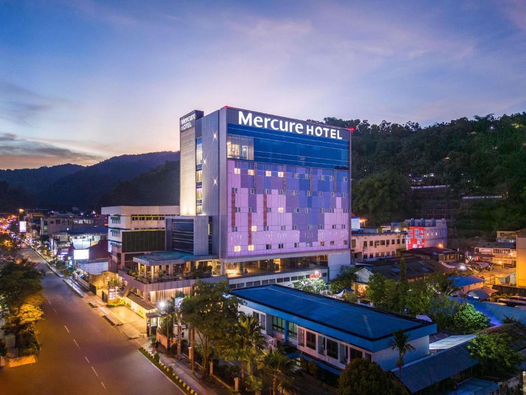 a night view of a metro hotel in a city at Mercure Jayapura in Jayapura