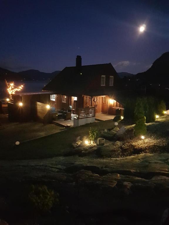 a house lit up at night with lights at Cabin in Hjelmeland in Hjelmeland